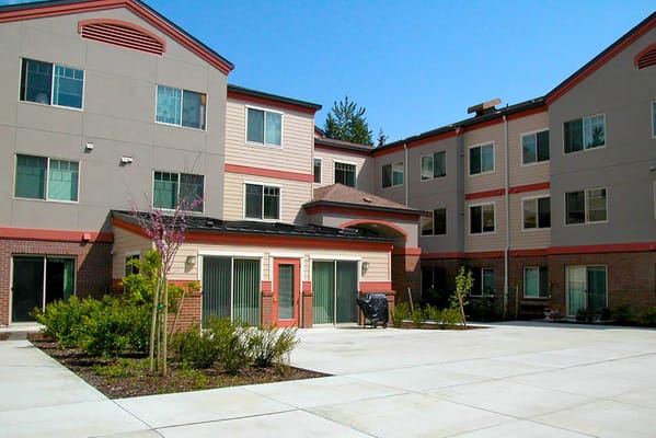 Exterior of Sunset Garden Senior Living Apartments showing the courtyard.