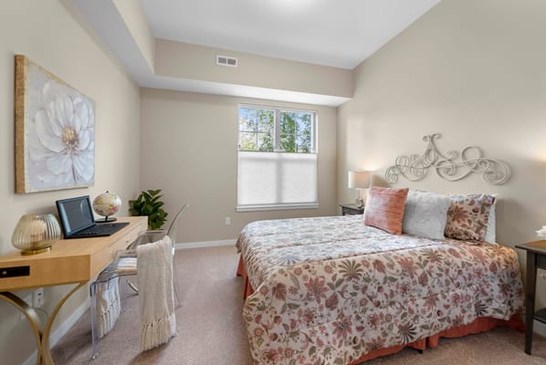 Cozy private room with floral bedding and workspace