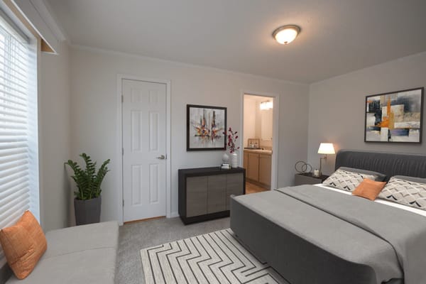 Stylish bedroom with a bed, dresser, and artwork