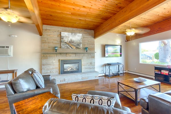 Warm living room with comfortable seating and a fireplace