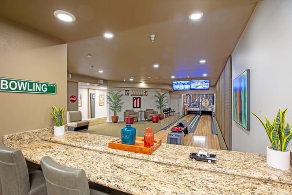 Indoor bowling area with seating and decor