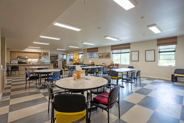 Dining area in a senior living facility with tables and chairs