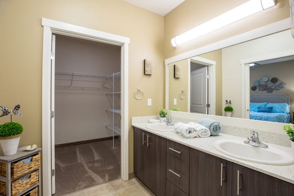 Modern bathroom with dual sinks and storage