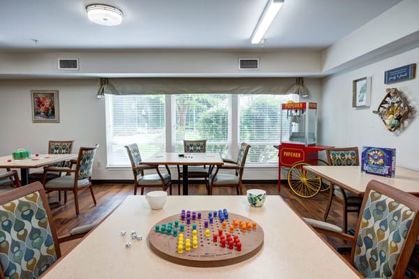 Interior view of game room with tables, games, and popcorn machine