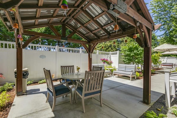 Covered gazebo with seating and decorative plants