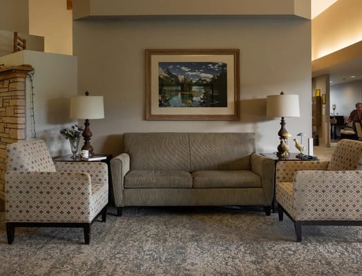 Living room with a couch, two chairs, and decorative lamps.