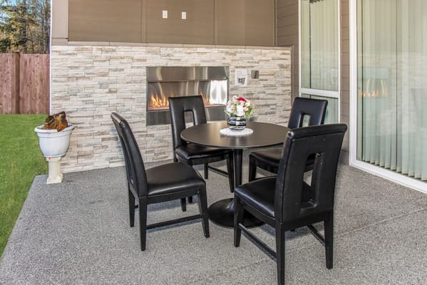 Outdoor patio area with a table and chairs