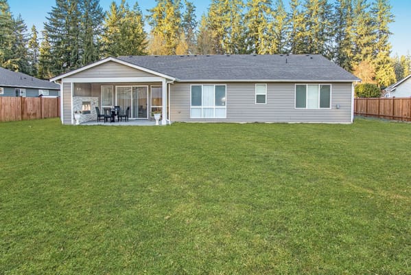 A cozy back view of a senior living facility with a lawn