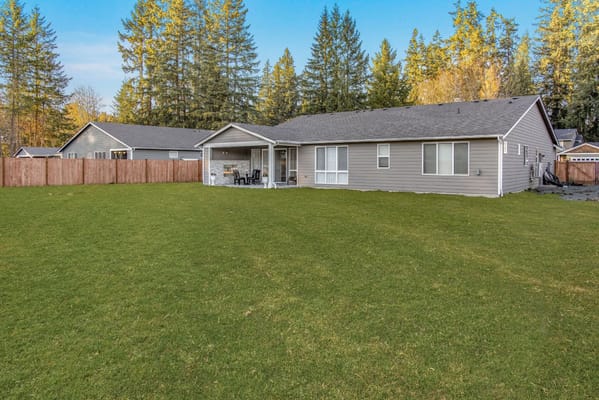 Exterior view of a senior living facility with a backyard