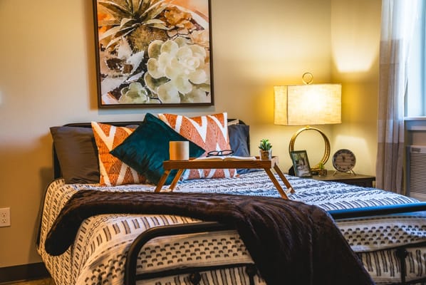 Cozy resident room with artwork and decorative pillows