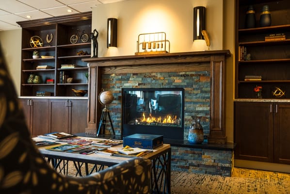 Cozy common area with a fireplace and bookshelves