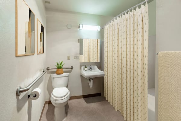 Clean bathroom with shower and sink