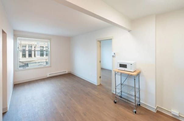 Empty interior room with a window and microwave