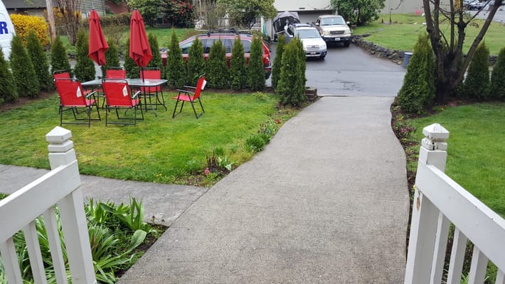 Seating area with red umbrellas and chairs in a garden