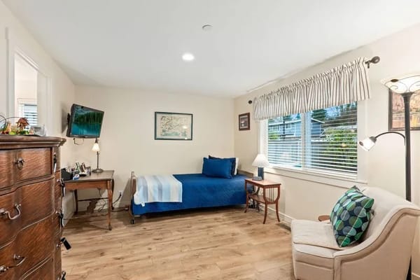 Cozy resident room with a bed and seating area