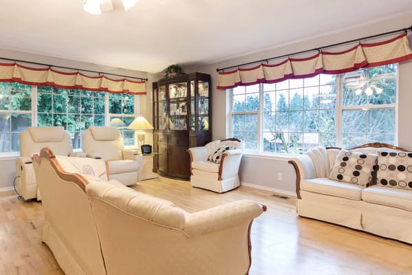 Bright and spacious living room with comfortable seating and large windows