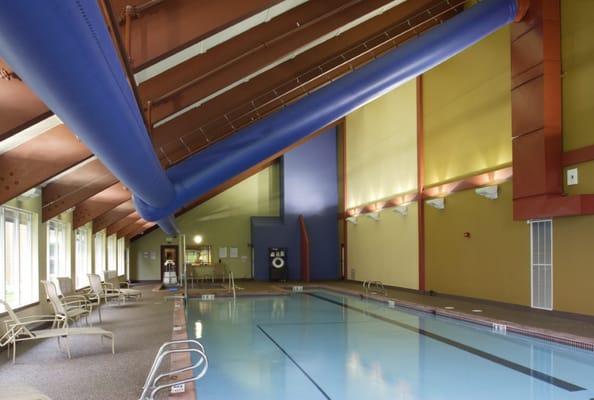 Indoor swimming pool area with seating