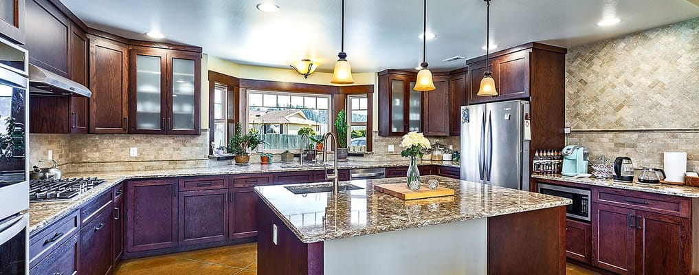 Bright kitchen with modern appliances and granite countertops
