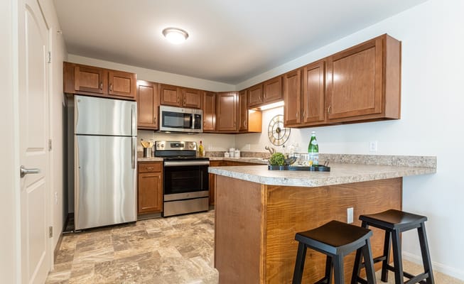 Modern kitchen with stainless steel appliances and a granite countertop