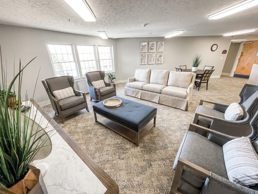 Comfortable living room seating area with a sofa and armchairs