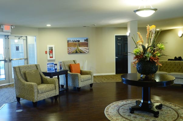 Cozy lobby area with seating and floral arrangement