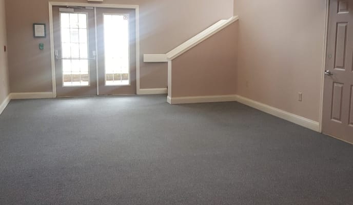 Spacious lobby with double doors and a staircase