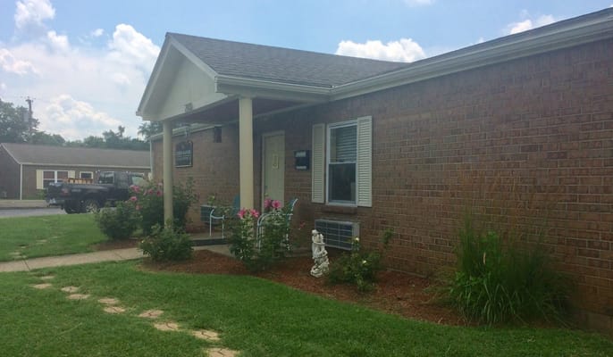Front entrance of Sisson Manor with flowerbeds