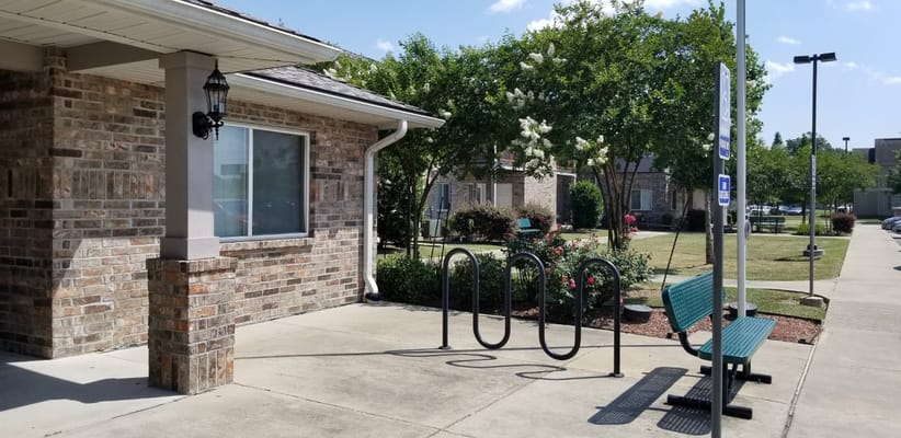 Entrance area of Hooper Springs with bike rack and garden