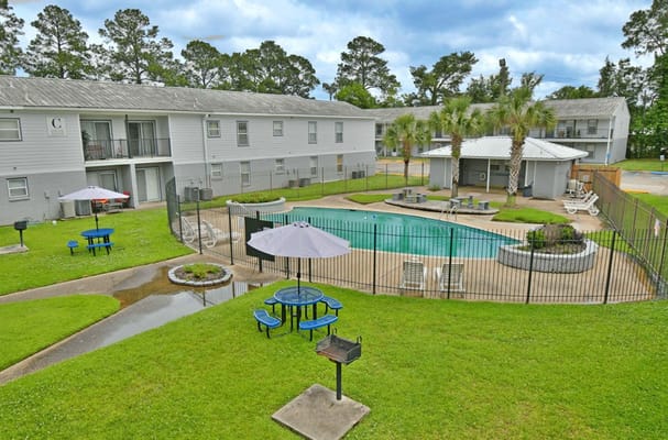 Overview of the pool area with lounge chairs and seating