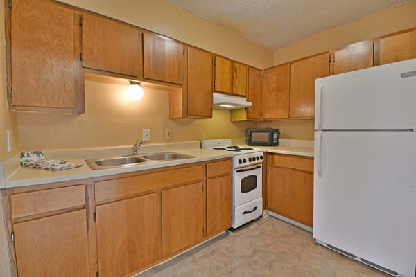 Cozy kitchen with wooden cabinets and appliances
