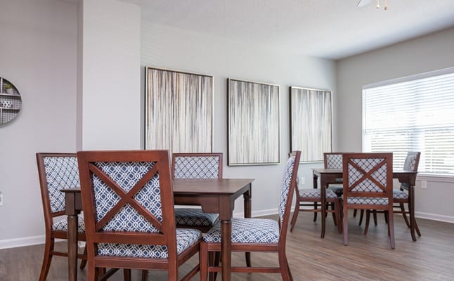 Cozy dining area with wooden tables and patterned chairs