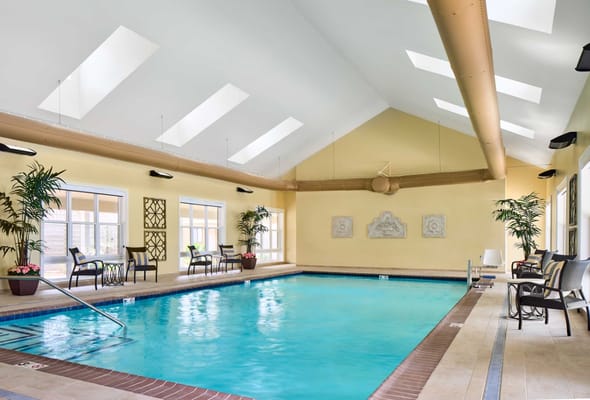 Indoor swimming pool area with lounge chairs