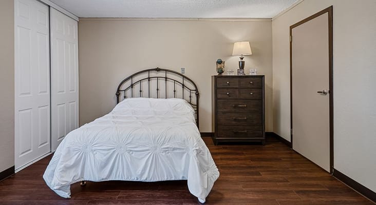 Cozy private bedroom with a bed and dresser