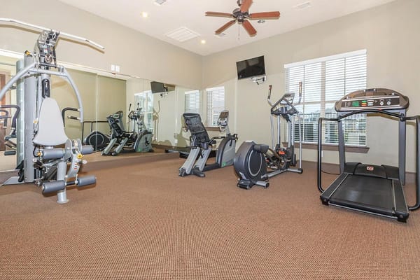 Fitness center with gym equipment and large mirrors