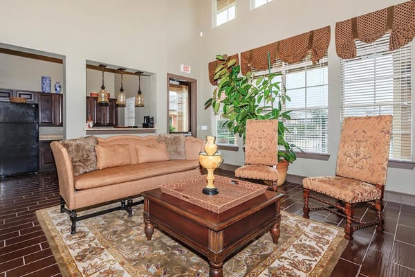 Cozy living room with a sofa, chairs, and decorative plant.