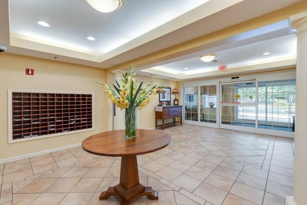 Bright lobby area with floral arrangement and seating
