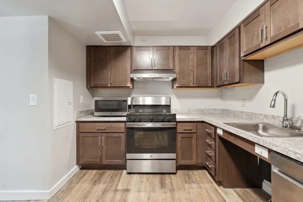 Spacious kitchen with stainless steel appliances and wooden cabinets