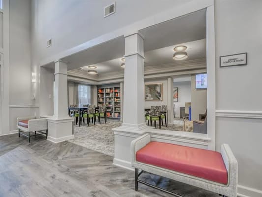 Interior view of the library and computer room with seating and shelves.