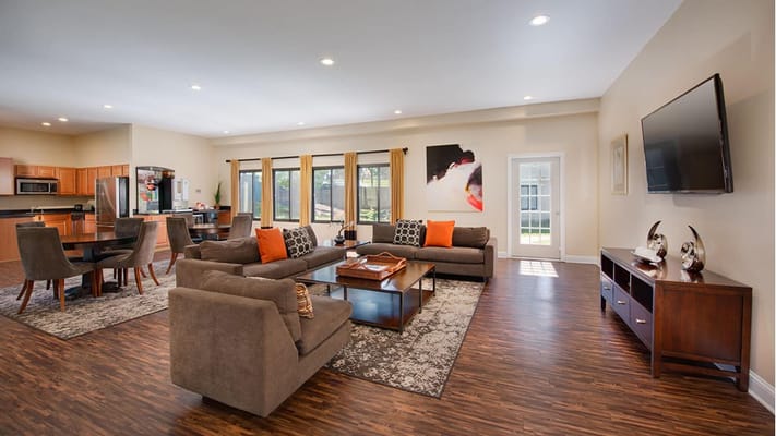 Bright and inviting living room with comfortable seating and dining area.
