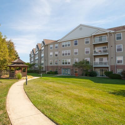 View of the exterior of Victoria Park Apartments, featuring a gazebo and a walking path.