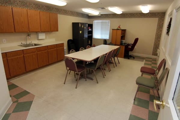 Common area with tables and chairs in a senior facility
