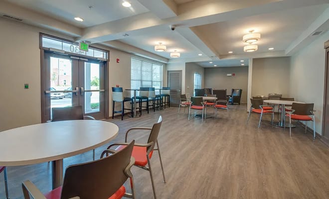 Bright common area with tables and chairs in Merritt Station Apartments