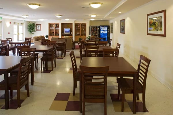 Dining area with tables and chairs set for meals
