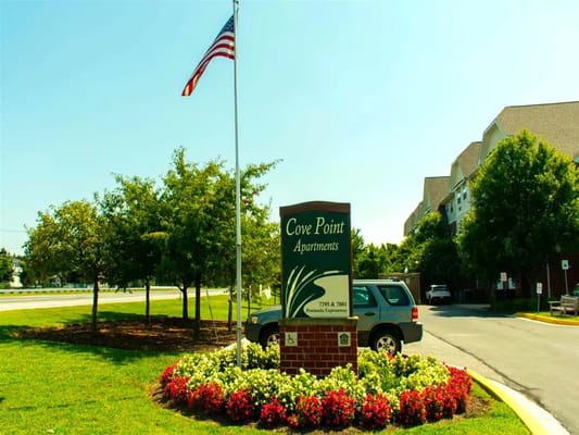Entrance sign for Cove Point Apartments with landscaping