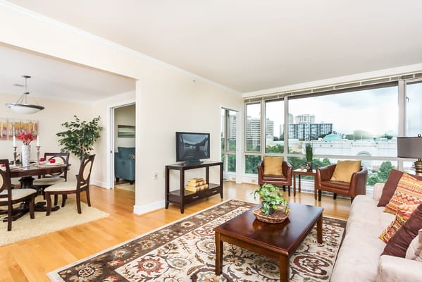 Bright common area with large windows and furniture