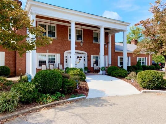 Front entrance of the King's Daughters & Sons Home with green landscaping