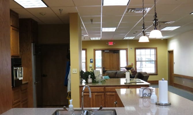 Living room area with couches and kitchen counter