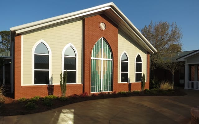 Exterior view of Haven Nursing Center with stained glass window.