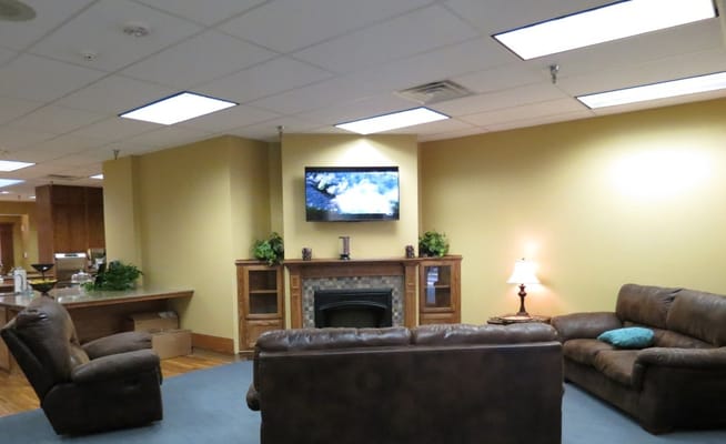 Lounge area with sofas and a TV in Haven Nursing Center