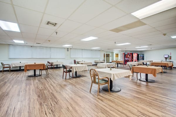 Dining area with tables and chairs in a spacious room